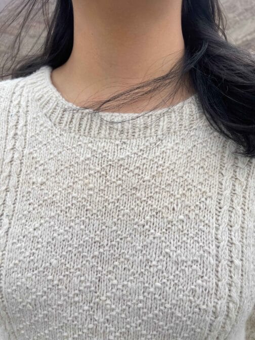 Close-up of lambswool sweater texture showing detailed hand-knitting