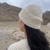 Close up of cream colored ribbed wool beanie