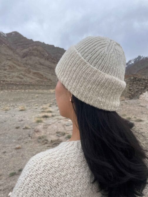 Close up of cream colored ribbed wool beanie